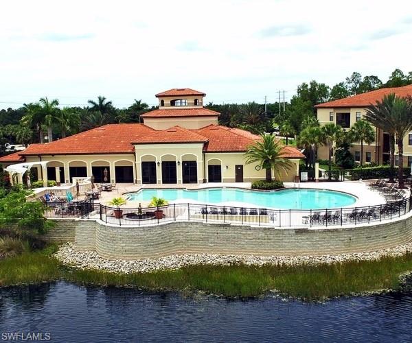 a front view of a house with a yard with swimming pool