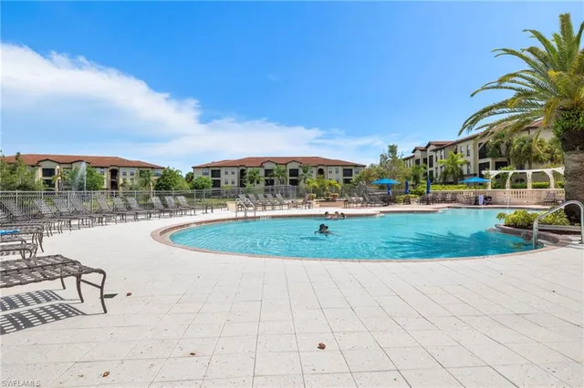 a view of a swimming pool and a yard