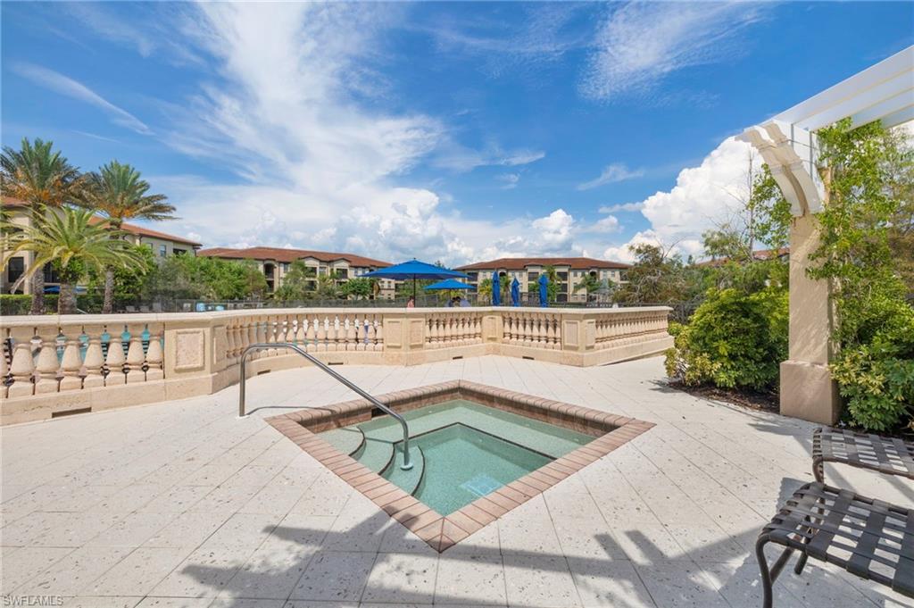 12940 Positano Circle, Unit 204 Naples, FL 34105 - Photo 25 of 39 a view of a swimming pool with a patio