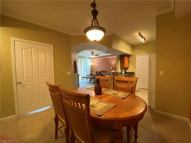 a view of a dining room with furniture and chandelier