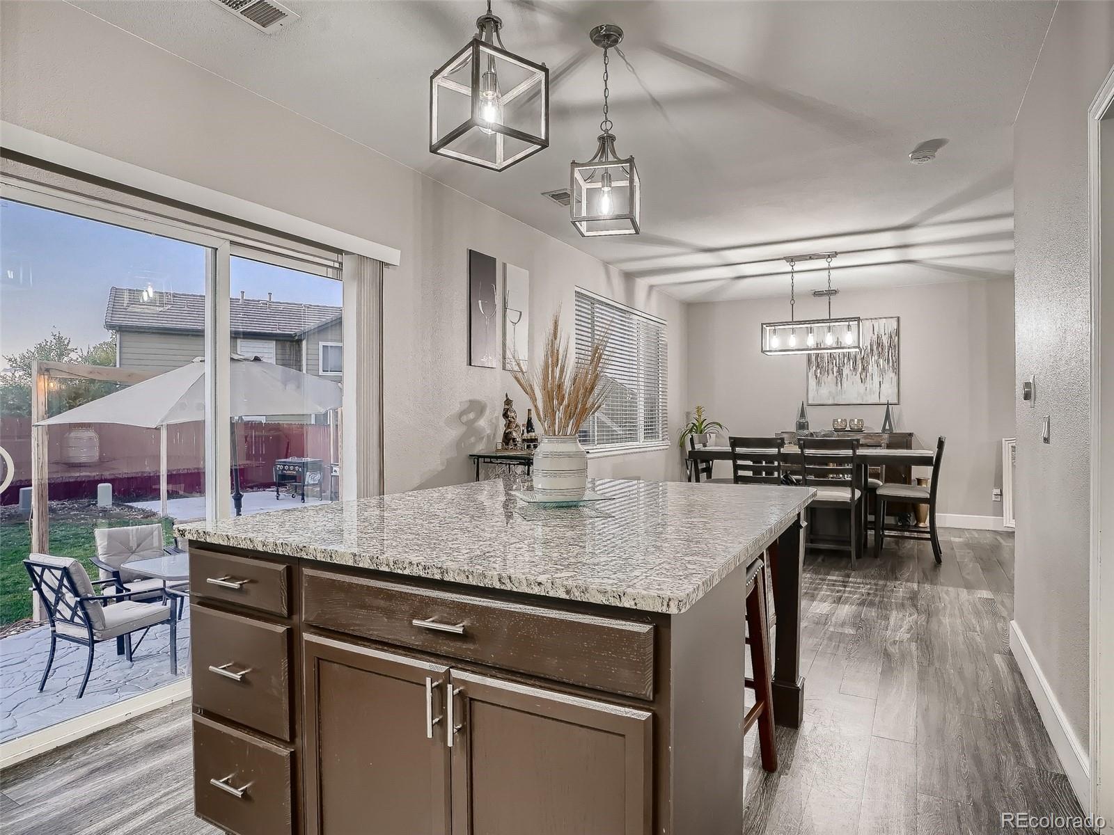 10047 Crystal Circle Commerce City, CO 80022 - Photo 13 of 28 a kitchen with a counter space a sink and cabinets