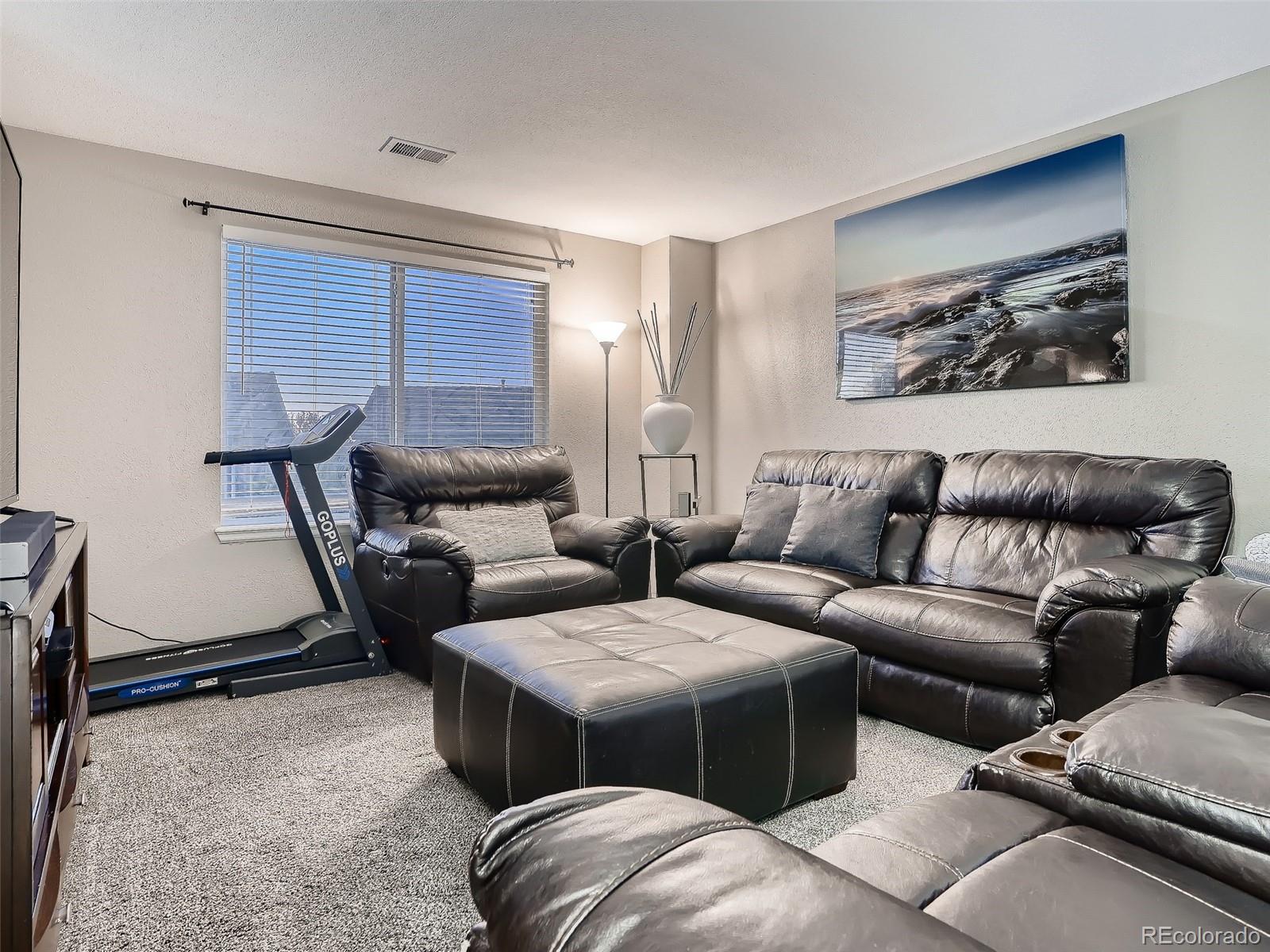 10047 Crystal Circle Commerce City, CO 80022 - Photo 22 of 28 a living room with furniture and a window