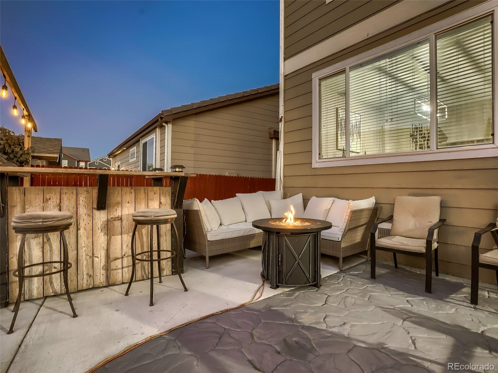 10047 Crystal Circle Commerce City, CO 80022 - Photo 25 of 28 a roof deck with table and chairs
