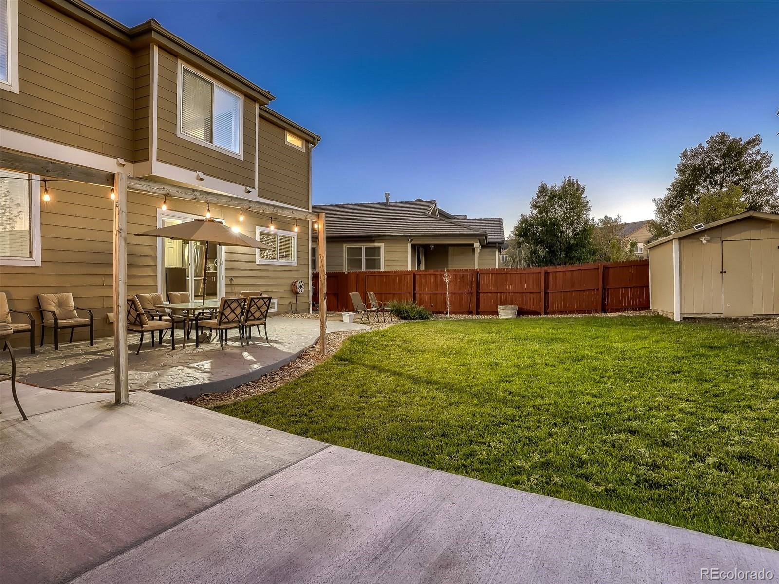 10047 Crystal Circle Commerce City, CO 80022 - Photo 27 of 28 a front view of house with yard