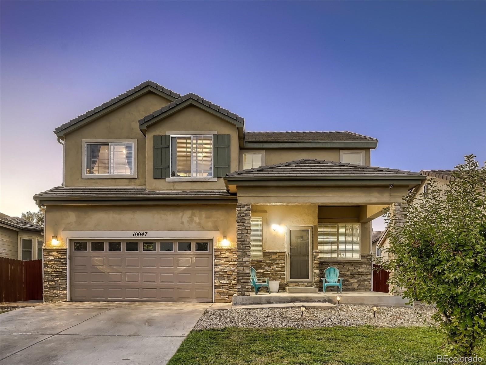 10047 Crystal Circle Commerce City, CO 80022 - Photo 28 of 28 a front view of a house with a yard