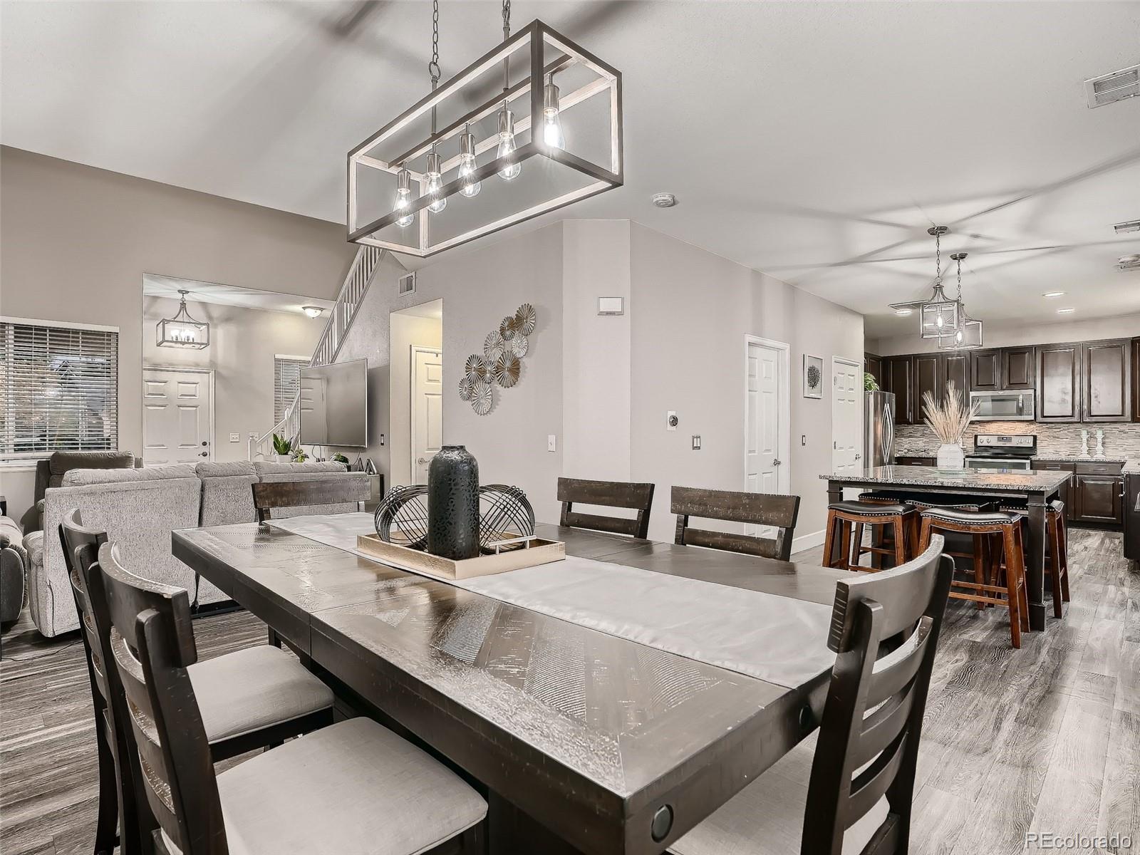 10047 Crystal Circle Commerce City, CO 80022 - Photo 9 of 28 a view of a dining room with furniture and a chandelier