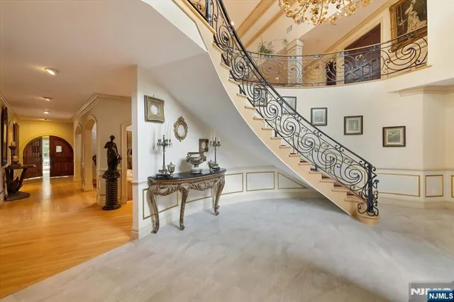 a living room with furniture a fireplace and a chandelier