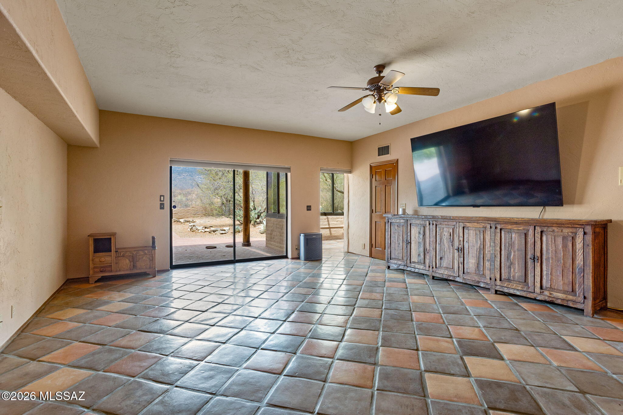 7171 South X9 Ranch Road Vail, AZ 85641 - Photo 15 of 50 Dbl doors to Primary Suite, sliding door to patio, entry to sunroom. Large walk-in closet stool & TV included. Console negotiable.