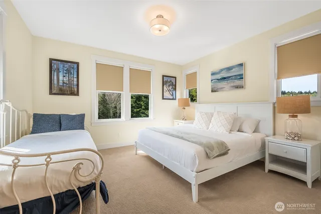 a bedroom with a bed and a large window