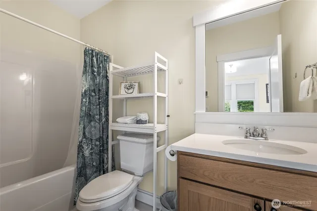 a bathroom with a sink toilet vanity and shower