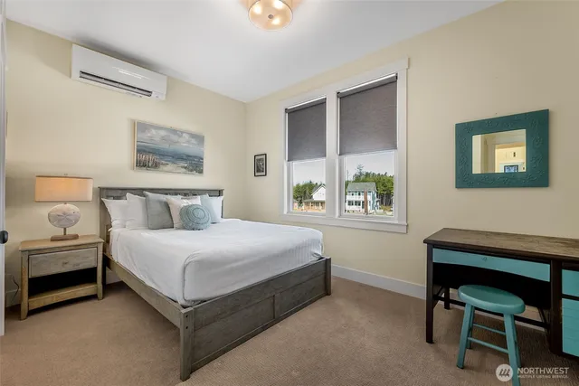 a bedroom with a bed table and window