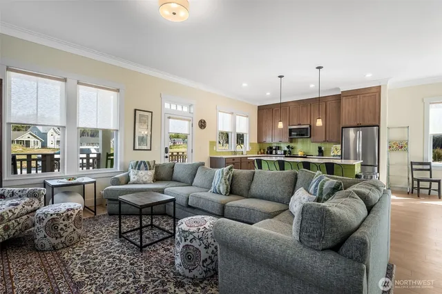 a living room with furniture kitchen and a view of kitchen