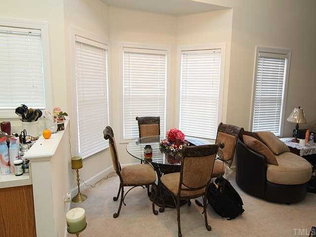 7024 Sandy Forks Road, Unit 301 Raleigh, NC 27609 - Photo 4 of 11 Dining room with bay window is open to kitchen and living room makes it easy to entertain. Dining Room