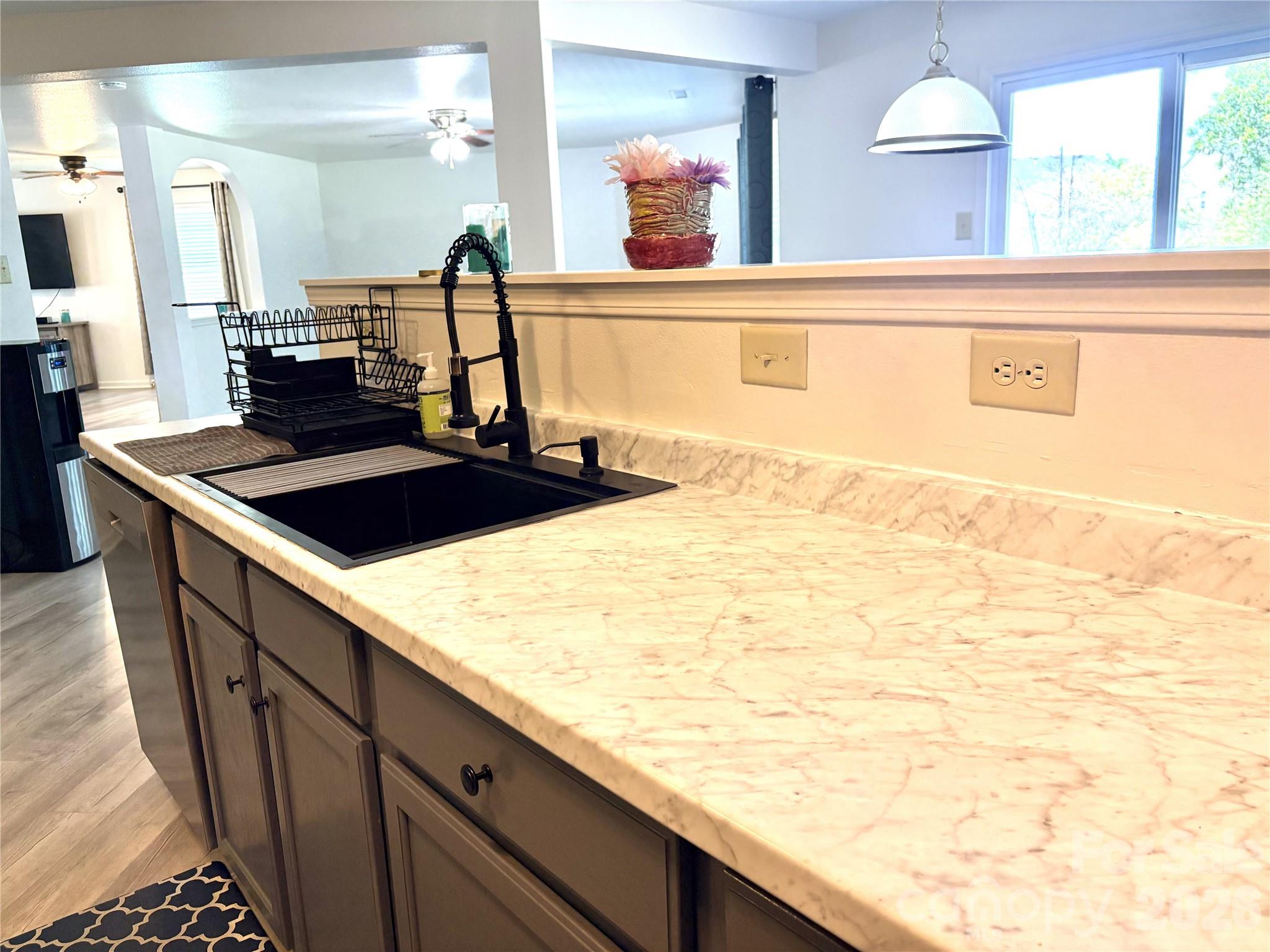 2514 Spring Breeze Way Monroe, NC 28110 - Photo 10 of 25 a kitchen with kitchen island a sink a stove and a window