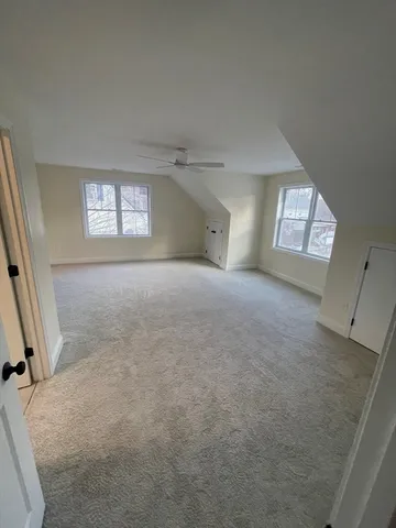 an empty room with windows and closet