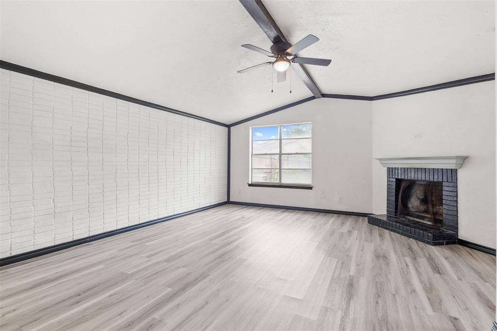 2802 Spring Valley Drive Bedford, TX 76021 - Photo 13 of 24 wooden floor in an empty room with a fireplace