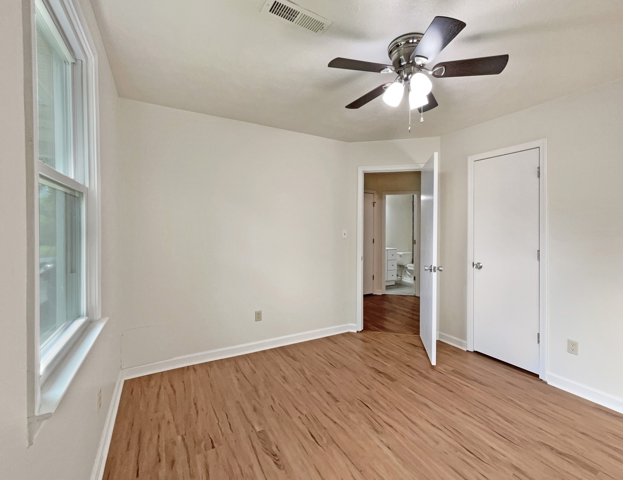 2139 River Road Clarksville, TN 37040 - Photo 8 of 17 a view of an empty room with wooden floor and a window