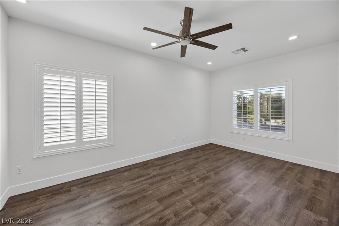 251 Integrity Ridge Drive Henderson, NV 89052 - Photo 16 of 32 Rich wood flooring pairs elegantly with plantation shutters in this serene, light-filled space.