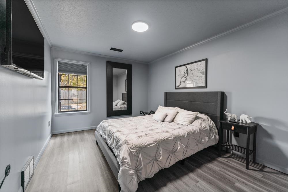 3358 Altruria Road Bartlett, TN 38135 - Photo 18 of 28 a bedroom with a bed and a flat tv screen on dresser