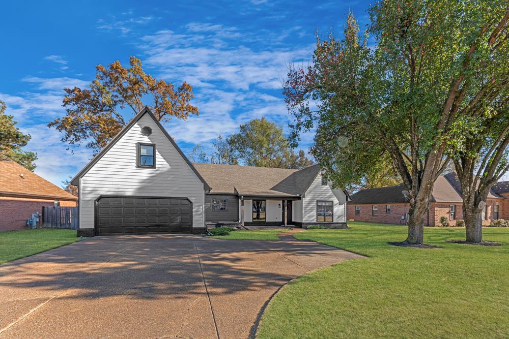 3358 Altruria Road Bartlett, TN 38135 - Photo 2 of 28 a front view of a house with a garden and trees