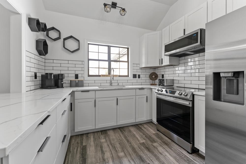 3358 Altruria Road Bartlett, TN 38135 - Photo 10 of 28 a kitchen with a stove a sink and a microwave