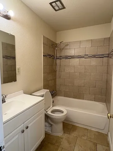 a bathroom with a sink a toilet and a bathtub