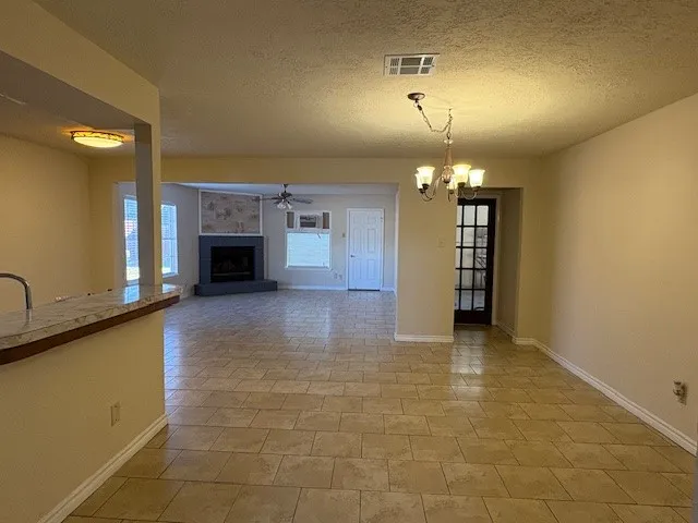 a view of a kitchen with a sink and a fireplace