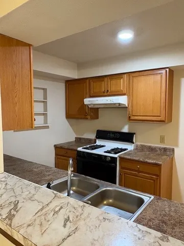 a kitchen with a stove and a sink