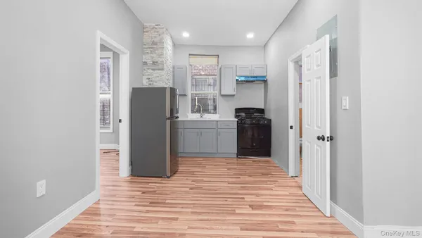 a kitchen with a refrigerator and a sink