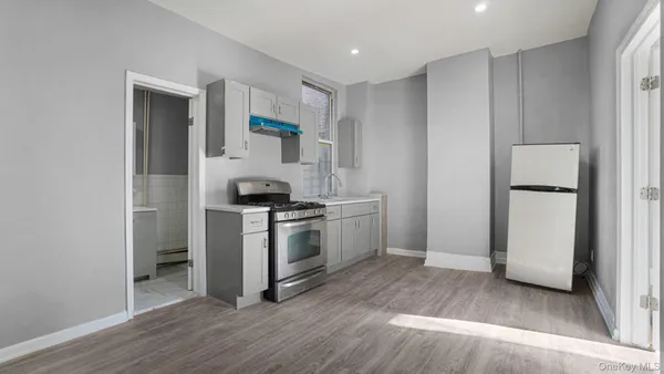 a kitchen with a refrigerator and a stove top oven