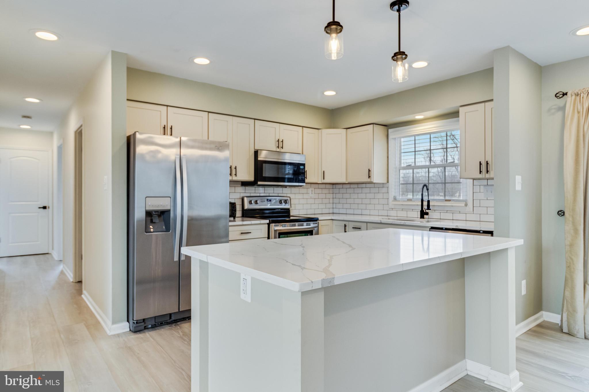 5510 Raphael Drive Pomfret, MD 20675 - Photo 4 of 10 a kitchen with stainless steel appliances a refrigerator sink and microwave