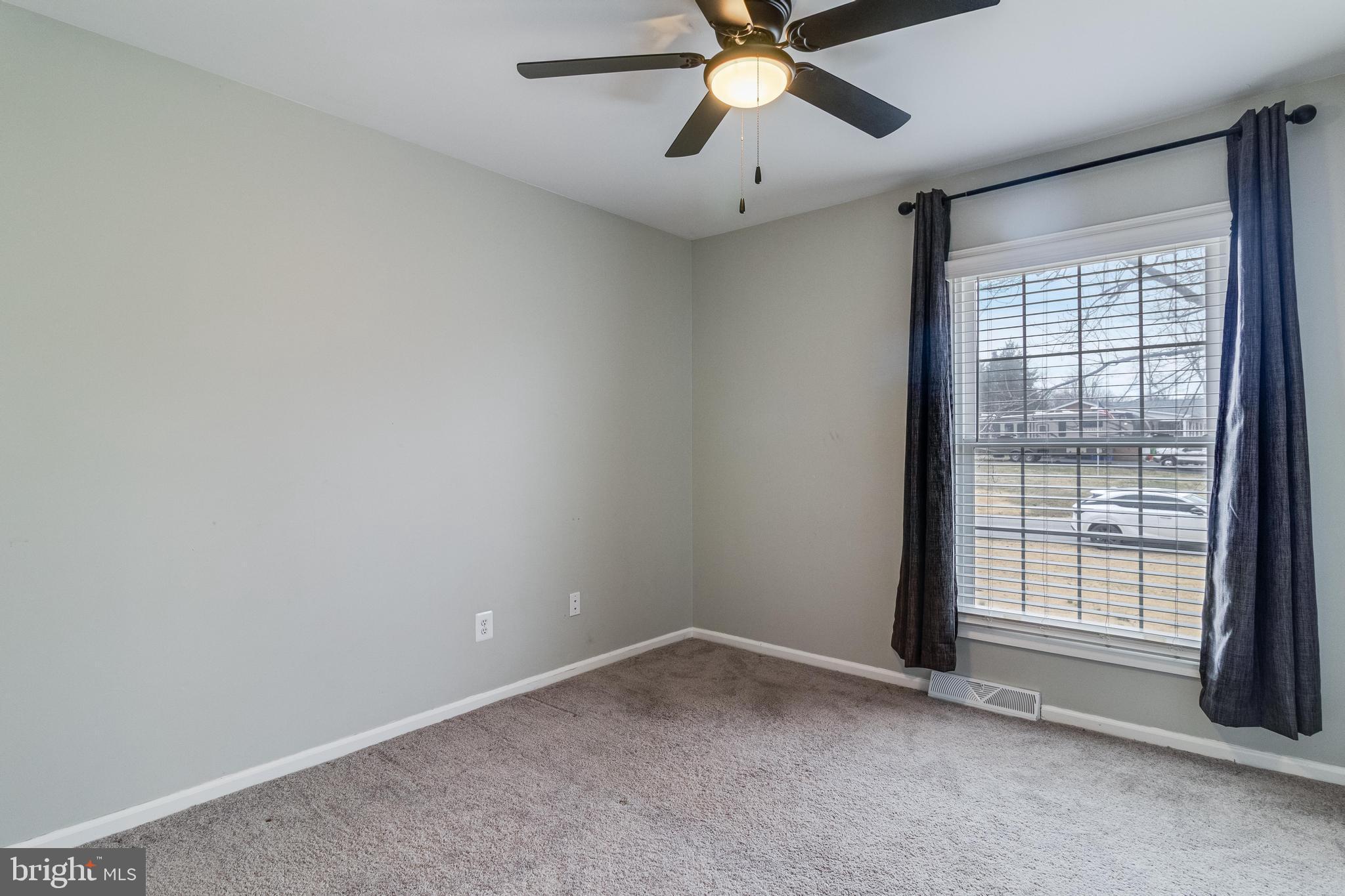 5510 Raphael Drive Pomfret, MD 20675 - Photo 8 of 10 an empty room with a window and a fan