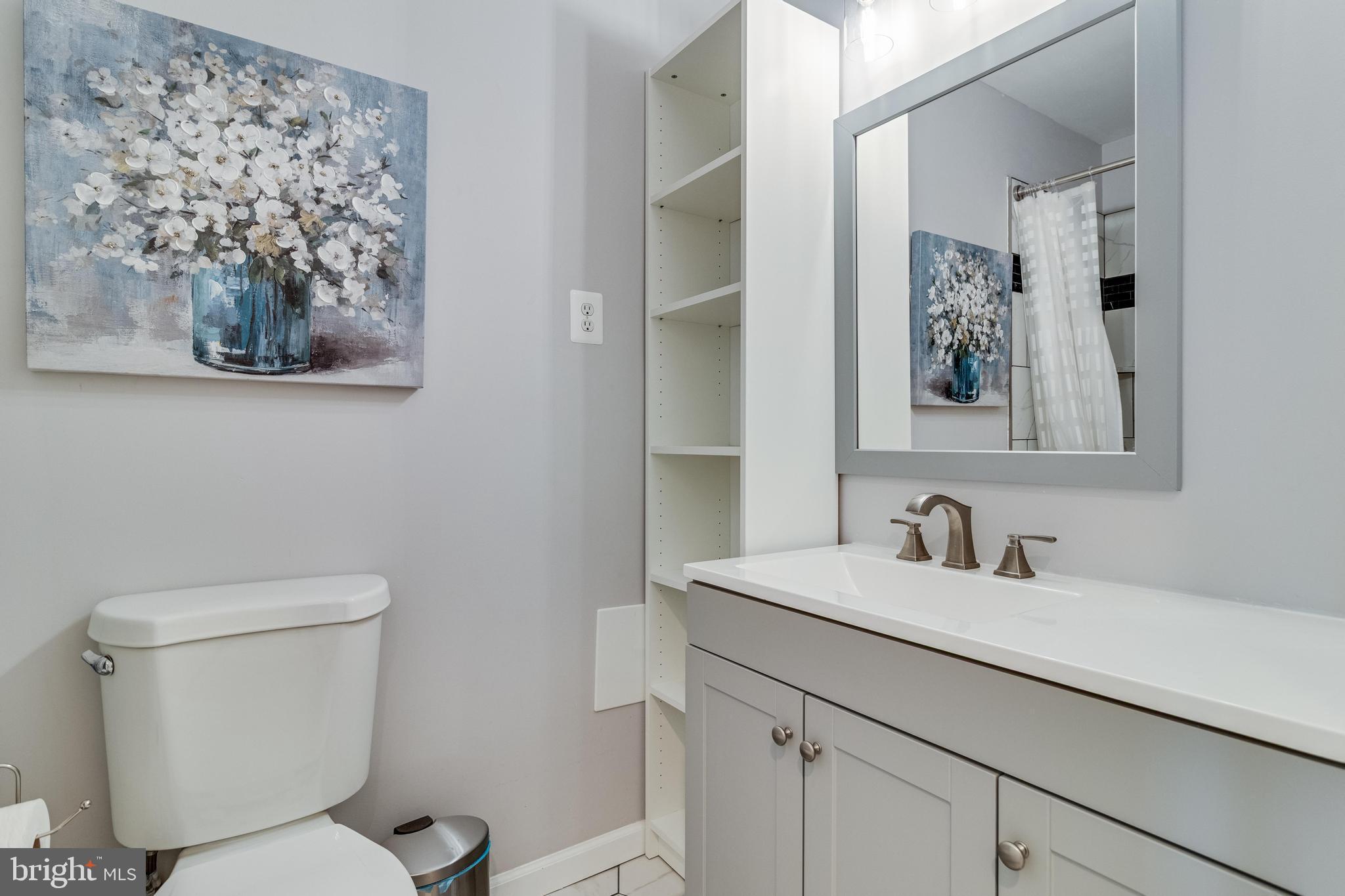 5510 Raphael Drive Pomfret, MD 20675 - Photo 10 of 10 a bathroom with a toilet sink and mirror