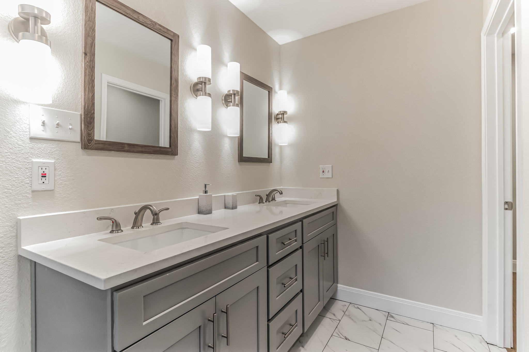 11406 Ruffed Grouse Drive Austin, TX 78758 - Photo 13 of 22 Clean lines and a spacious dual vanity highlight this beautifully renovated modern bathroom.