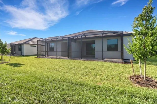 a view of a house with a backyard