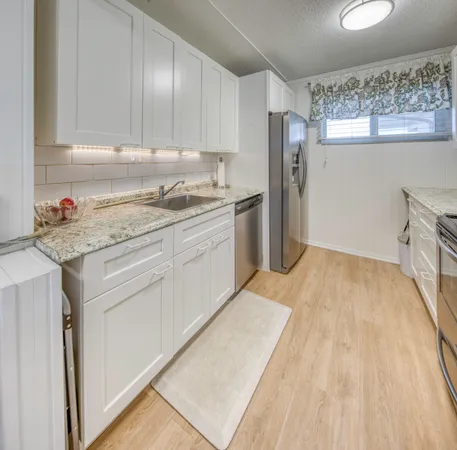 a kitchen with a sink stove and refrigerator