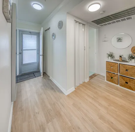 a room with a dresser and mirror