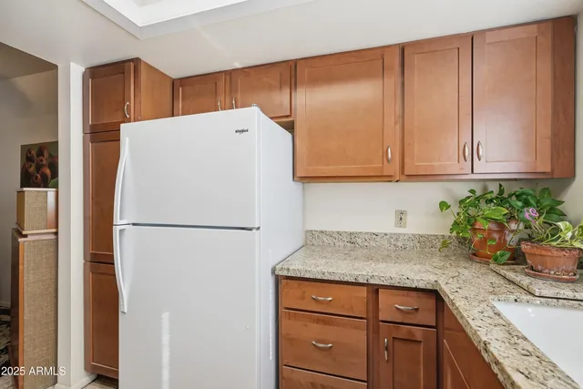 a white refrigerator freezer sitting in a kitchen