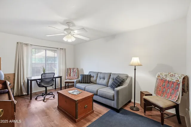a living room with furniture and a lamp