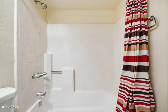 a bathroom with a shower and a sink