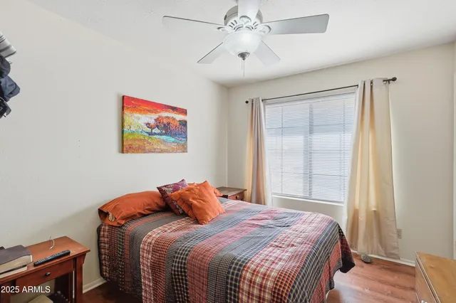 a bedroom with a bed and a painting on the wall