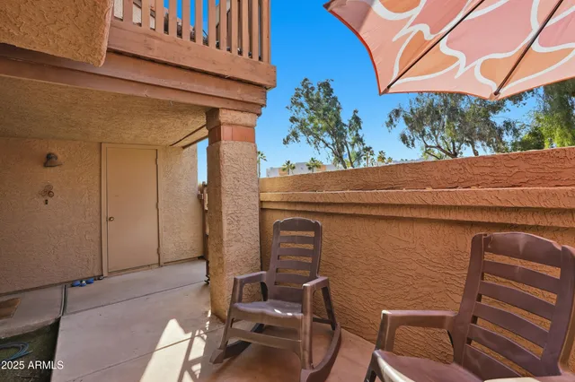 a backyard of a house with an outdoor seating