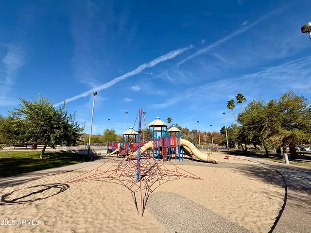 a view of a park with swings and slides