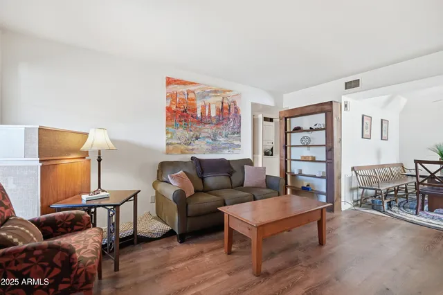 a living room with furniture a rug and a window