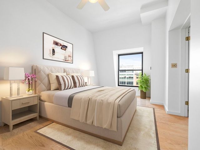 a spacious bedroom with a bed and a window