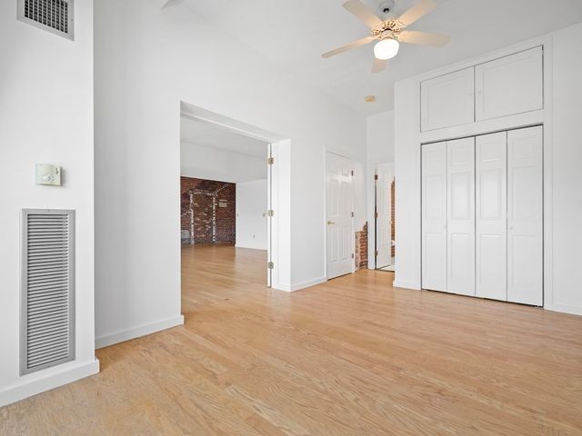 a view of an empty room with a ceiling fan
