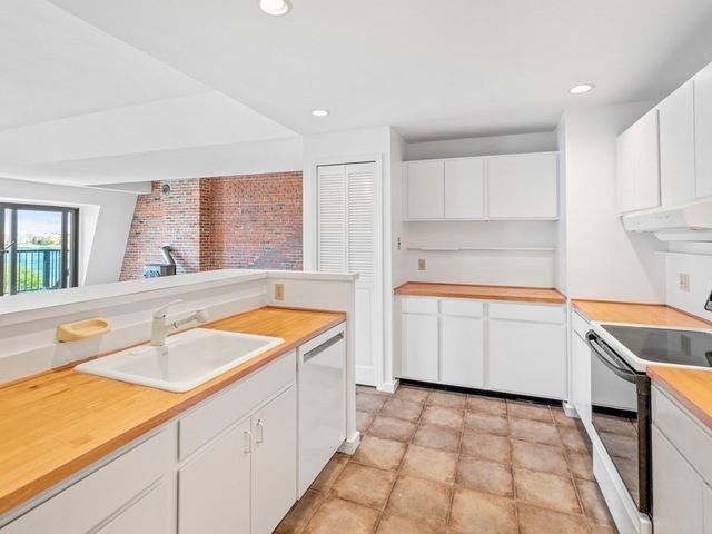 a kitchen with a sink stove and cabinets