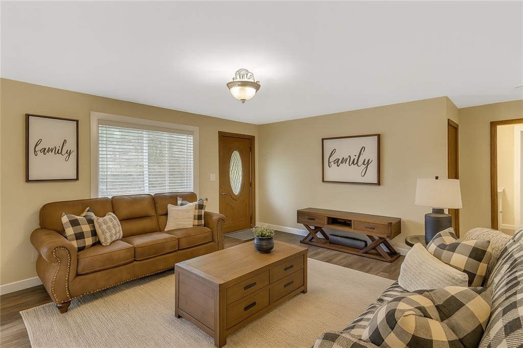 1225 Mercer Road Ellwood City, PA 16117 - Photo 4 of 36 The living room offers a cozy escape from the day’s hustle.