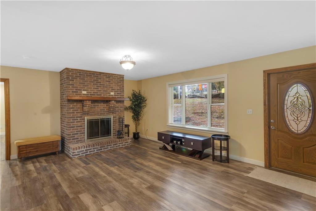 1225 Mercer Road Ellwood City, PA 16117 - Photo 6 of 36 The living room radiates warmth with its inviting fireplace and soft natural light...