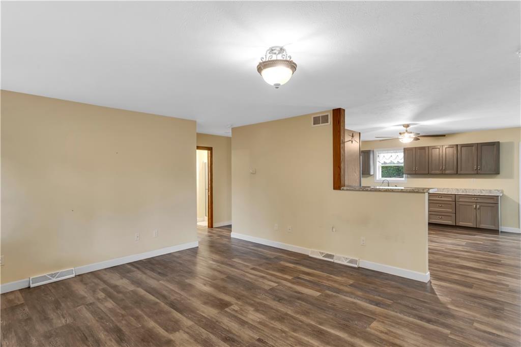 1225 Mercer Road Ellwood City, PA 16117 - Photo 7 of 36 Laminate flooring flows throughout the home, blending warm and cool tones for versatile decorating.